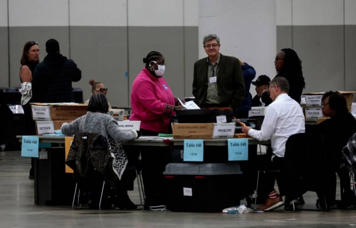In US swing states, officials brace for conspiracy theories and violence 