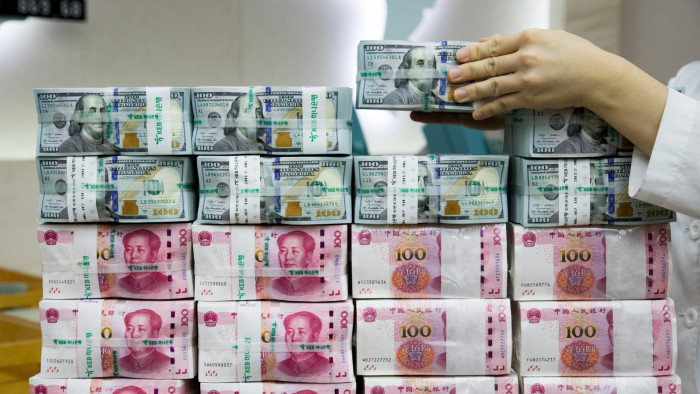 Dollar drops from two-year high, yuan hits 16-month low