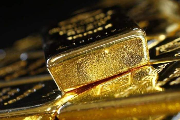 Gold prices steady as dollar jumps ahead of Fed rate decision 