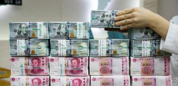 Dollar drops from two-year high, yuan hits 16-month low