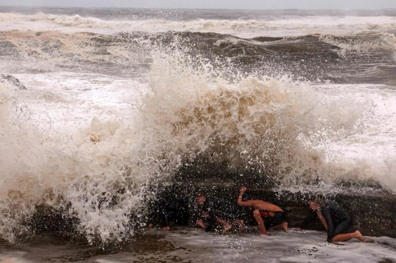Cyclone Alfred downgraded as millions of Australians stay indoors 