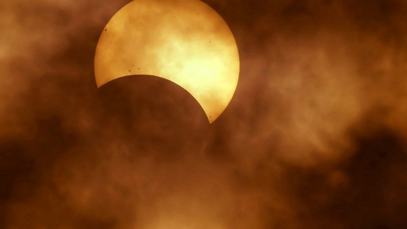 Partial solar eclipse: The moon take a 'bite' out of the sun -  LIVE 