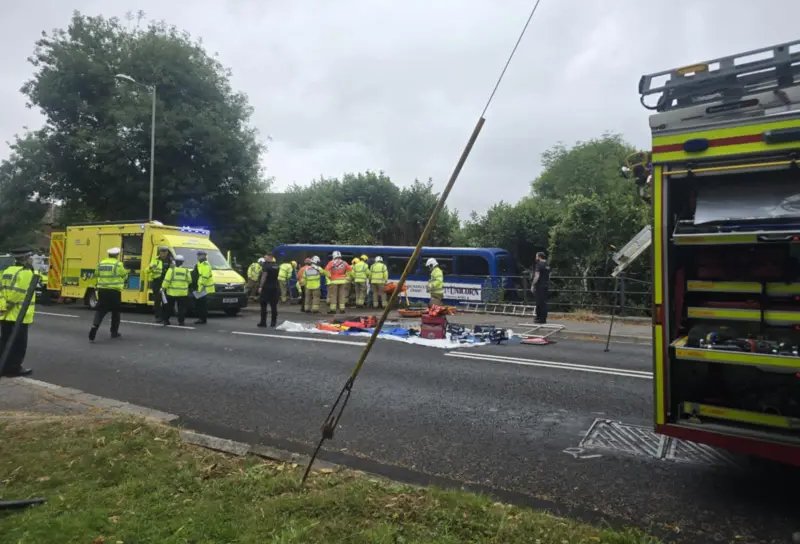 Dozen injured as bus carrying students crashes into river in southern England