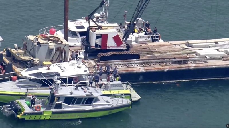 Two children die at Miami sailing camp in boat collision with barge