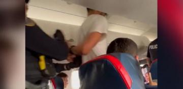 Delta connection flight makes emergency landing after passenger tries to open emergency exit