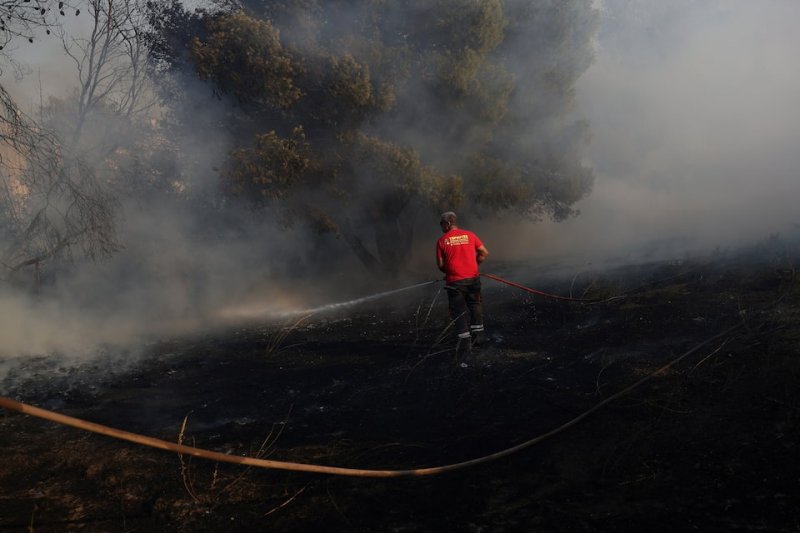 Greece wildfire contained, but high winds keep evacuations underway