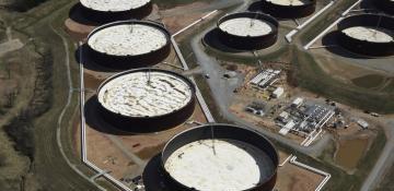 Oil set for monthly drop as traders balance glut and geopolitics