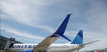 United Airlines passengers evacuate via emergency slides at Japan’s Kansai Airport after fire alert