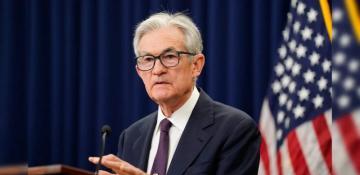 U.S. stocks close mixed as Powell signals pause in rate cuts 