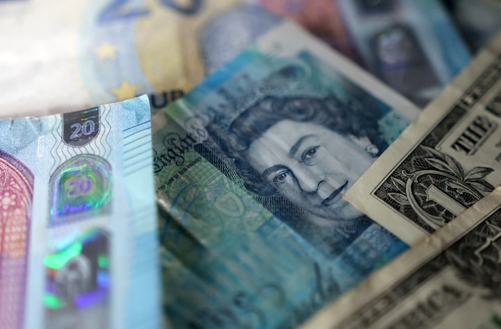 Sterling holds steady as traders await key UK economic data 