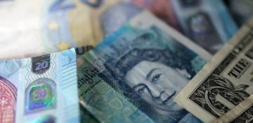 Sterling holds steady as traders await key UK economic data 