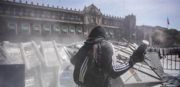 Protesters march in Mexico City during annual military parade 