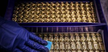 Gold slips as firm dollar, jobs data keep investors cautious