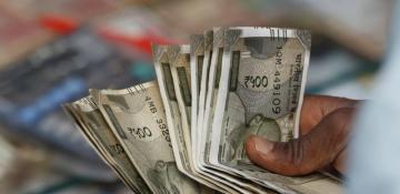 India's rupee slides to fresh low amid market pressures