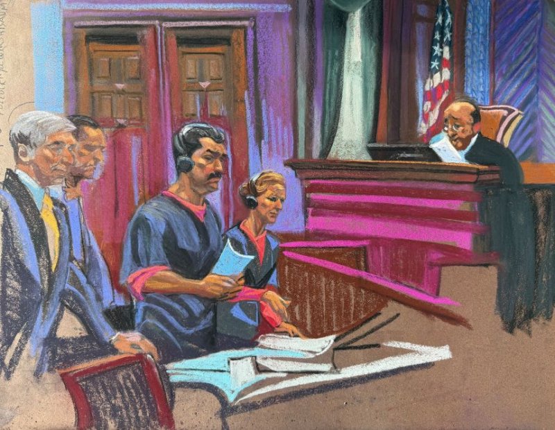 Maduro glances at wife as couple appear in court in jail uniforms