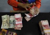 Indonesian rupiah crashes to record low against US dollar
