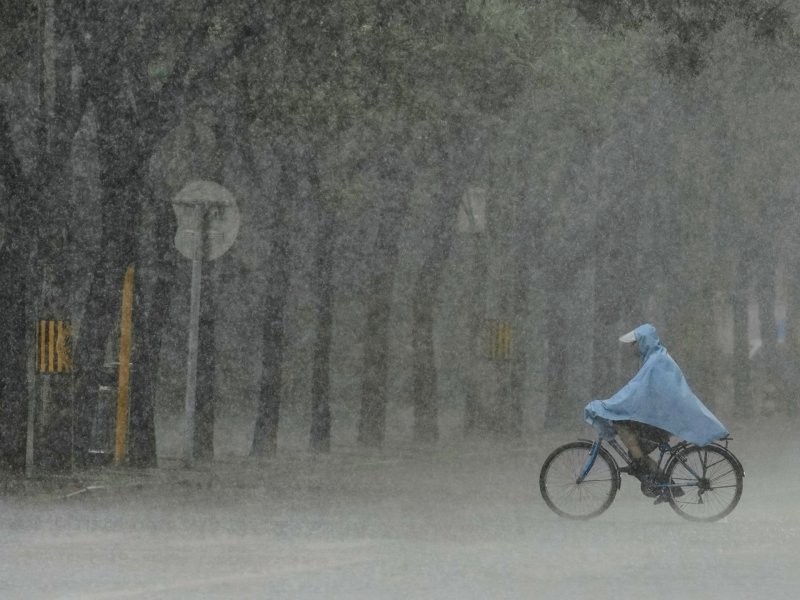 Why has China issued blue alerts for rainstorms and severe weather?