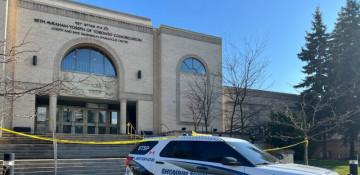 Officer dead, suspect linked to consulate shooting flees in Canada