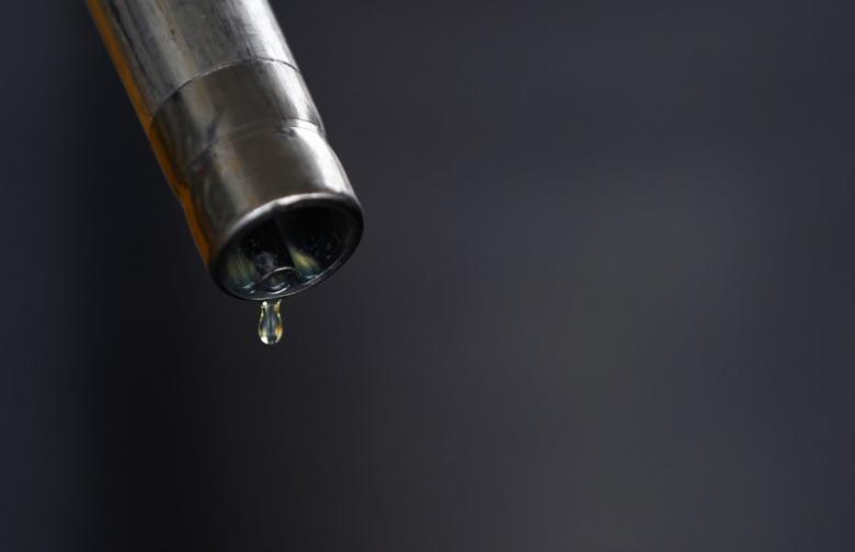 Oil slips further below $56 on report of U.S. inventory jump