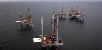 Oil jumps 3 percent as dollar falls, U.S. rig count drops