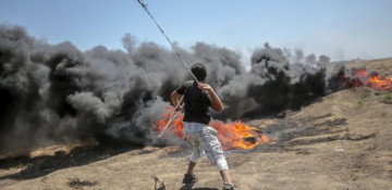 Tension in Gaza as Palestinians begin to bury 58 dead