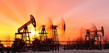 Oil edges up as U.S. crude stocks fall, Iran sanctions weigh