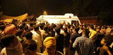 At least 50 killed after train runs over crowd in India