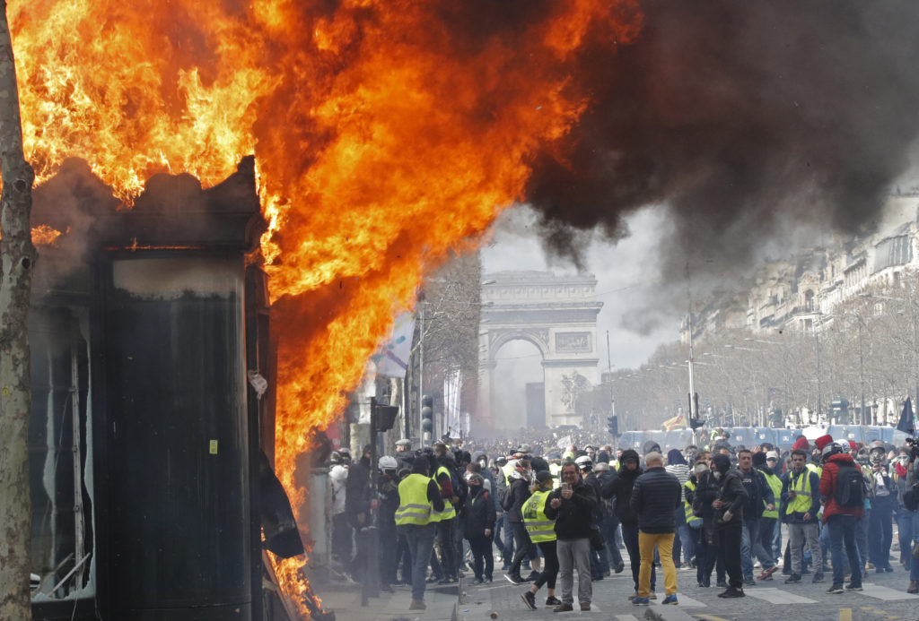 France bans some yellow vest protests in Paris after riots