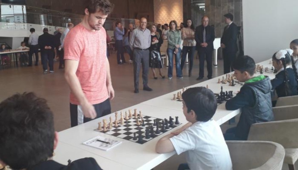 Magnus Carlsen plays chess with Azerbaijani children from Nagorno-Karabakh