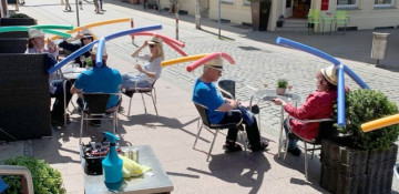 German cafe customers wear swimming pool noodle float hats to help with social distancing