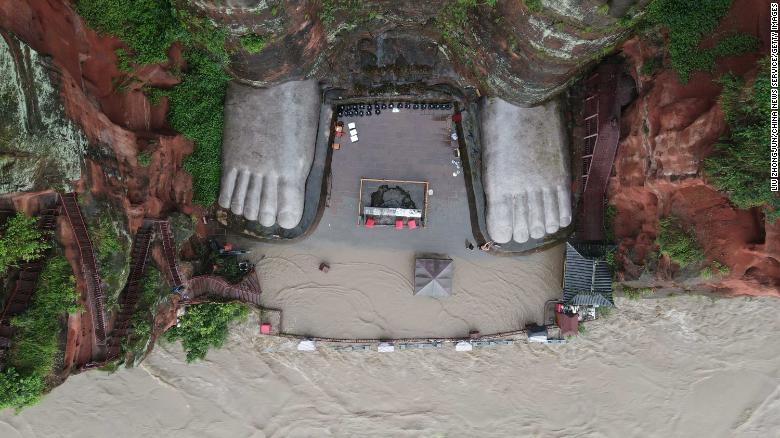 Flood waters reach the toes of China's famous giant Buddha statue