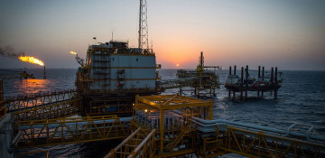 Oil hits more than one-year high on supply cuts, stimulus hopes