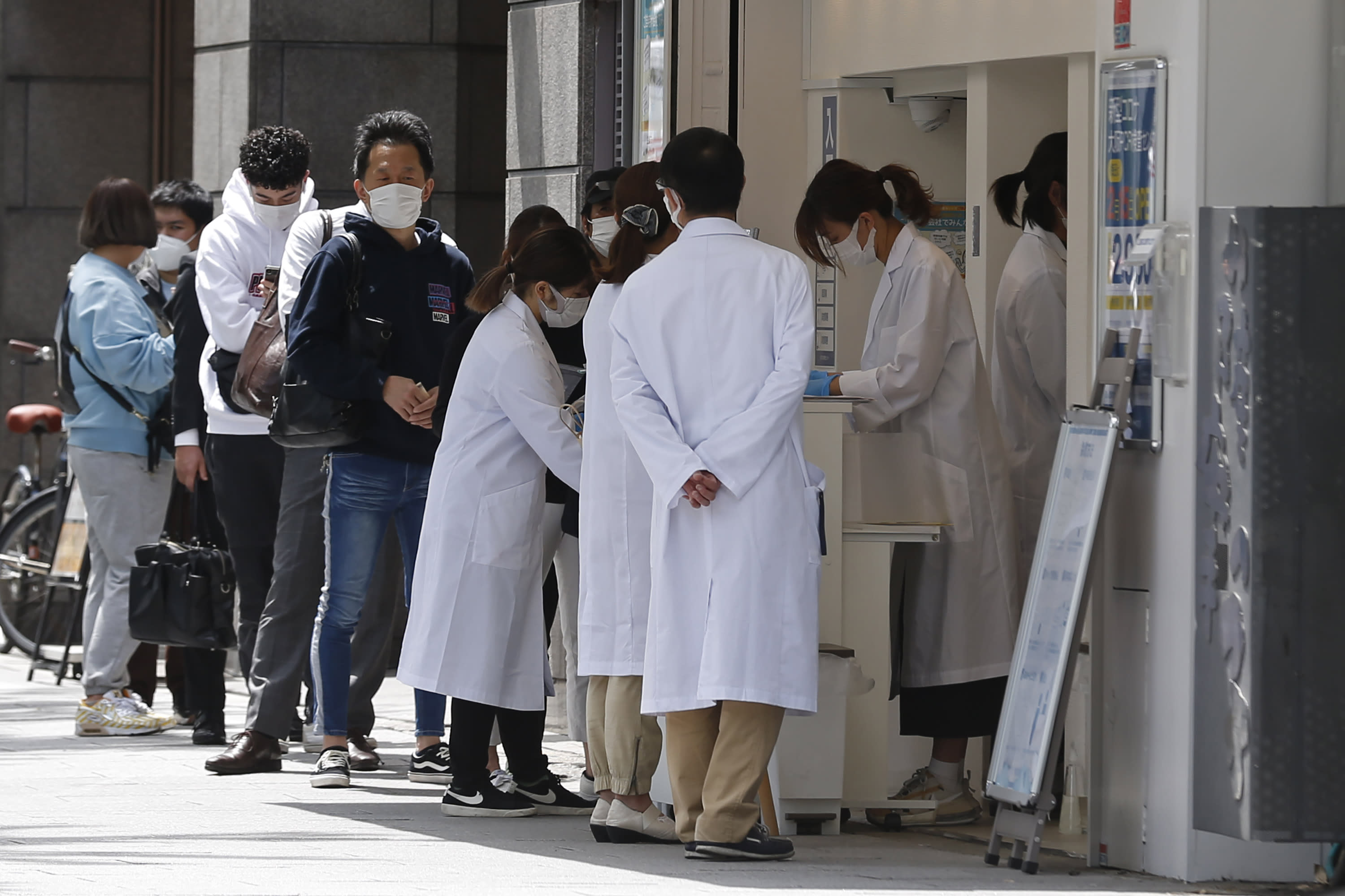 Japan to hospitalise only most serious COVID-19 cases in surge