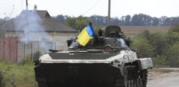 Ukraine troops raise flag over railway hub as advance threatens to turn into rout