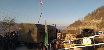 Several more vehicles of Russian peacekeepers pass freely along Lachin road